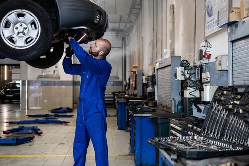 Vehicle technician check under a car