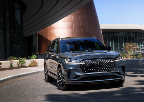 A gray 2025 Lincoln Aviator® SUV is parked outside a modern building with the sun shining. | Planet Lincoln Love Field in Dallas TX
