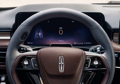 The steering wheel of 2025 Lincoln Aviator® SUV is shown with black and brown accents. | Planet Lincoln Love Field in Dallas TX