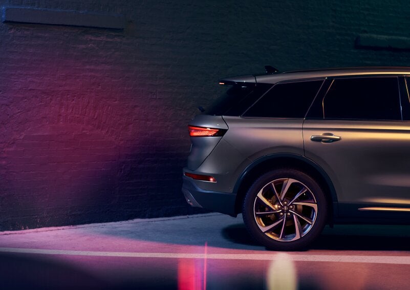 A dramatization of a 2025 Lincoln Corsair® SUV is shown backing up toward a wall. | Planet Lincoln Love Field in Dallas TX