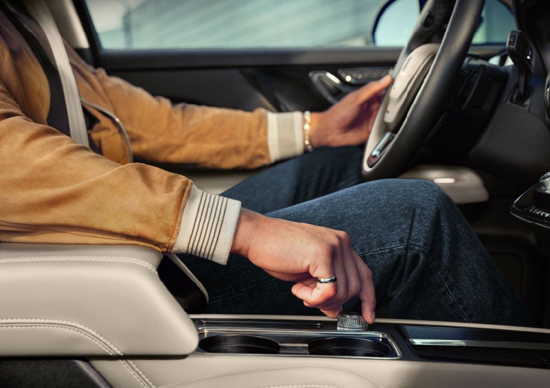 The driver of a 2024 Lincoln Corsair® SUV is shown selecting the drive mode. | Planet Lincoln Love Field in Dallas TX