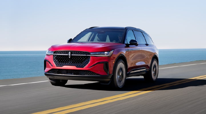 A 2025 Lincoln Nautilus® SUV is being driven on a seaside roadway. | Planet Lincoln Love Field in Dallas TX