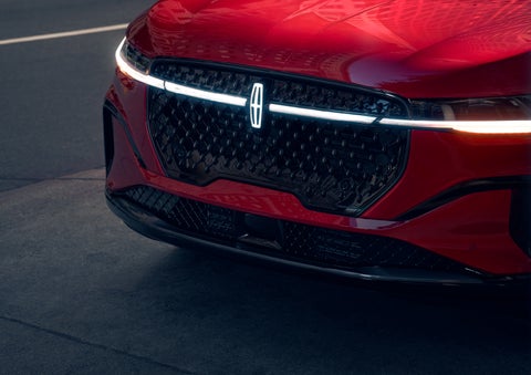 The available front LED light bar and center Lincoln Star logo glow at dusk. | Planet Lincoln Love Field in Dallas TX