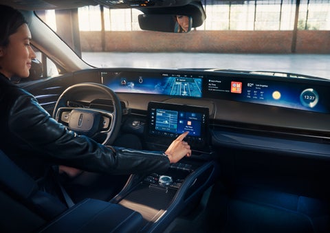 The driver of a 2025 Lincoln Nautilus® SUV interacts with the center touchscreen. | Planet Lincoln Love Field in Dallas TX