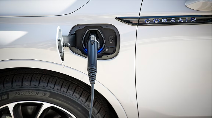 An electric charger is shown plugged into the charging port of a Lincoln Corsair® Grand Touring
model. | Planet Lincoln Love Field in Dallas TX