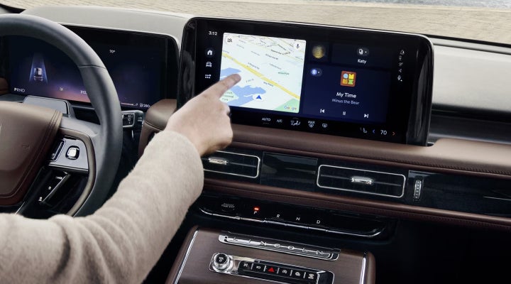A person is tapping the center display touchscreen of a 2026 Lincoln Aviator® SUV. | Planet Lincoln Love Field in Dallas TX