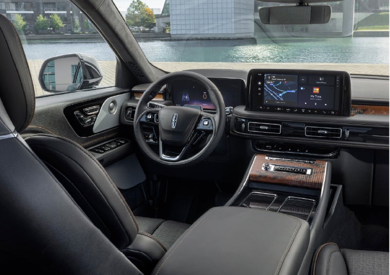 The interior of the 2026 Lincoln Aviator® SUV is shown parked with a view of a harbor through the windshield. | Planet Lincoln Love Field in Dallas TX