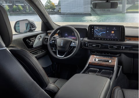 The interior of the 2026 Lincoln Aviator® SUV is shown parked with a view of a harbor through the windshield. | Planet Lincoln Love Field in Dallas TX