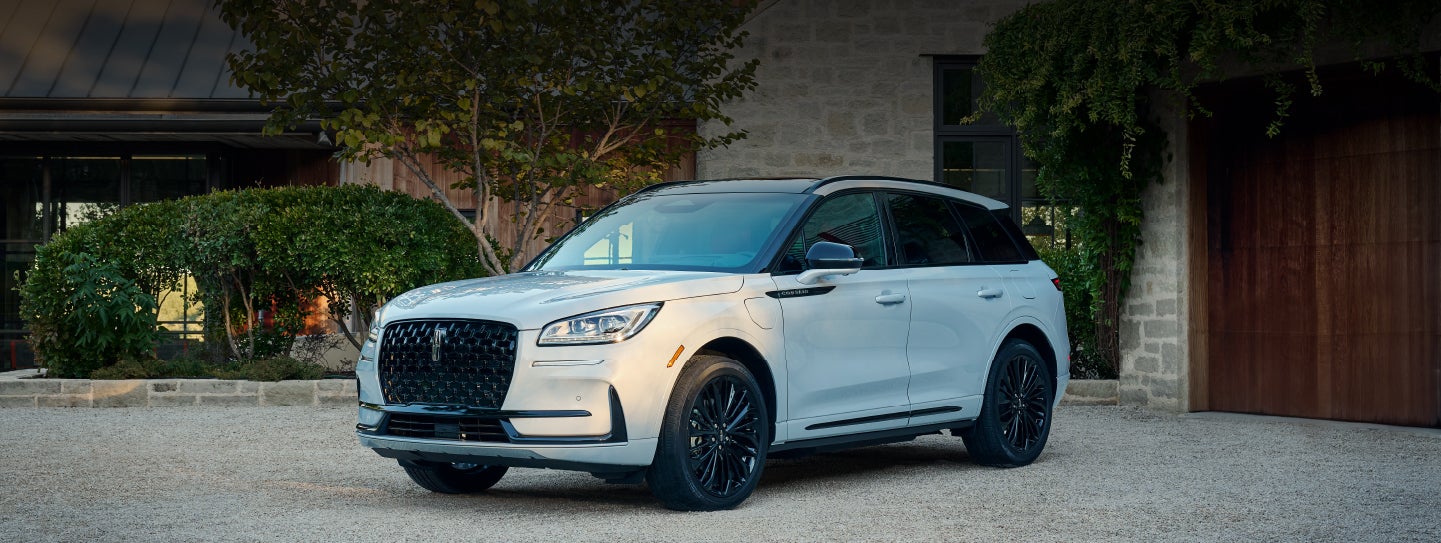 A 2026 Lincoln Corsair® SUV is parked in front off a luxury home. | Planet Lincoln Love Field in Dallas TX