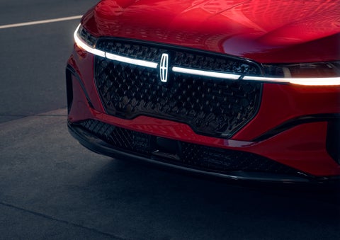 The available front LED light bar and center Lincoln Star logo glow at dusk. | Planet Lincoln Love Field in Dallas TX