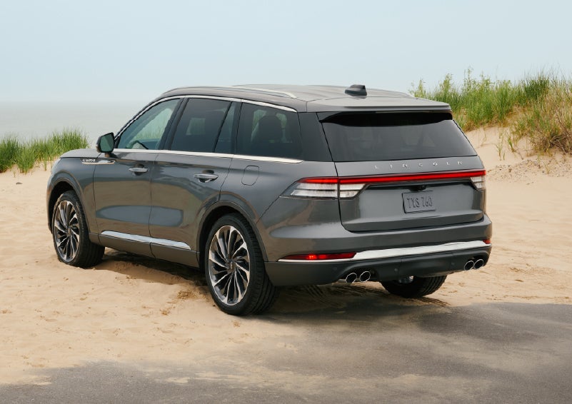 A 2027 Lincoln Aviator® SUV is parked next to sand dunes. | Planet Lincoln Love Field in Dallas TX