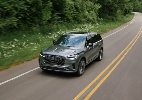 A 2027 Lincoln Aviator® SUV is being driven down a road. | Planet Lincoln Love Field in Dallas TX