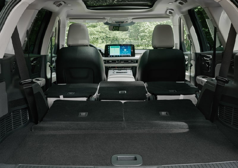 A rear to front view of the interior of a 2027 Lincoln Aviator® Black Label™ SUV shows the third and second rows folded flat | Planet Lincoln Love Field in Dallas TX