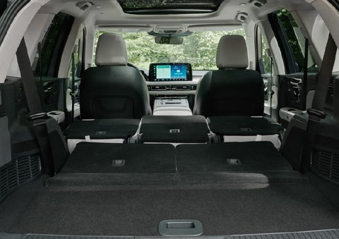 A rear to front view of the interior of a 2027 Lincoln Aviator® Black Label™ SUV shows the third and second rows folded flat | Planet Lincoln Love Field in Dallas TX