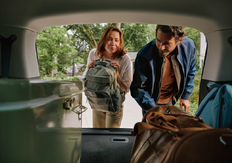 A couple loads luggage into the rear of a 2027 Lincoln Aviator® Black Label™ SUV..e 202 | Planet Lincoln Love Field in Dallas TX