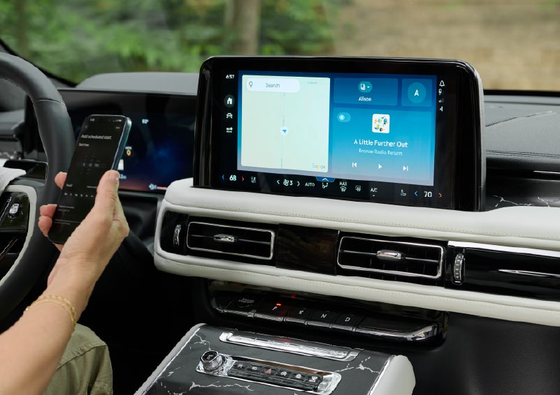 A person pairs thier phone with the center touchscreen of a 2027 Lincoln Aviator® Black Label™ SUV | Planet Lincoln Love Field in Dallas TX
